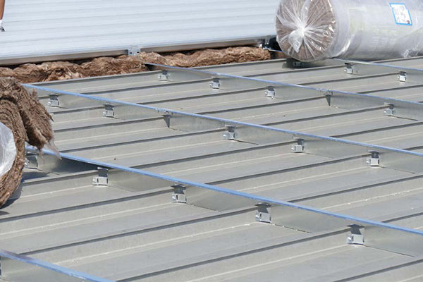 Metal Roof constructed with a structral sub-purlin system